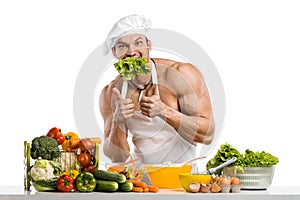 Man bodybuilder in white toque blanche and cook protective apron