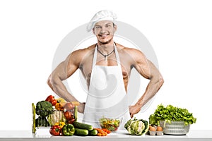 Man bodybuilder in white toque blanche and cook protective apron