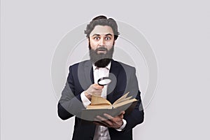 Man with book and magnifier