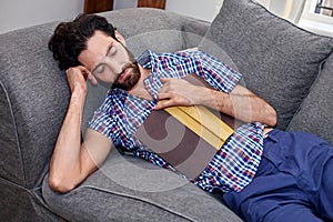 Man book sofa couch sleeping