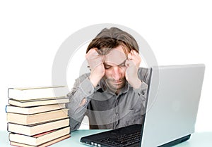 Man with books and laptop sleeping