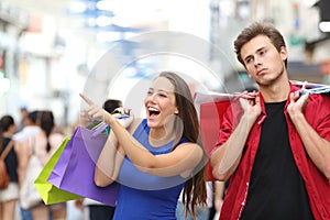 Man bored shopping with his girlfriend