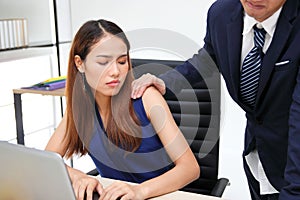 Man boss touching woman shoulder in workplace of office. Sexual harassment in office