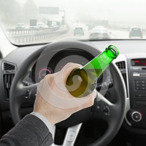 Man with bottle of beer while driving car - 1 to 1 ratio