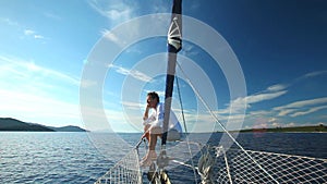 Man on the bow of sailing boat on Mediterranean sea.
