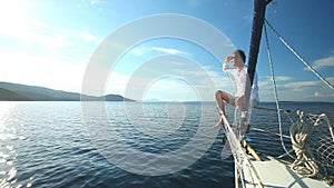 Man on the bow of sailing boat on Mediterranean sea.