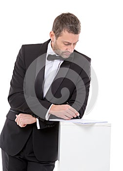 Man in a bow tie completing a form