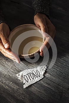 Man with a bowl of soup and word fall in spanish photo