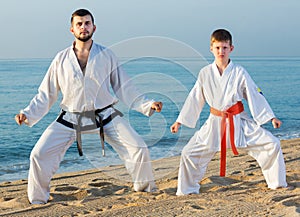 Man and boy exercising karate