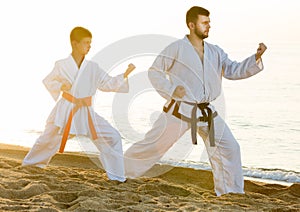 Man and boy exercising karate