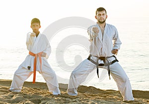 Man and boy exercising karate