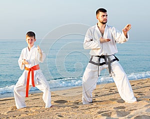 Man and boy exercising karate