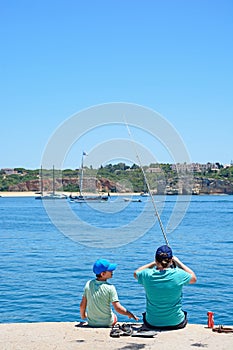 Man and boy fishing, Portimao.