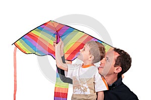 Man and boy hold kite above head