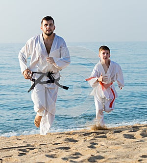 Man and boy practising karate