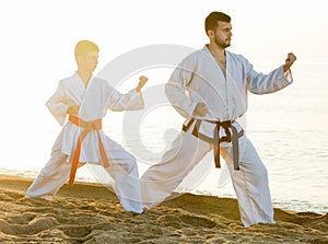 Man and boy practising karate