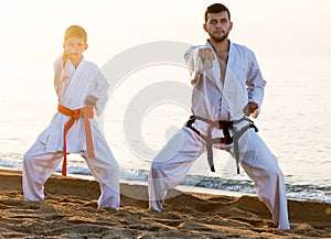 Man and boy practising karate