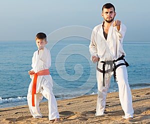 Man and boy practising karate