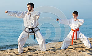 Man and boy practising karate