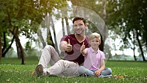 Man and boy show thumbs up, social support for single parent family, wellbeing