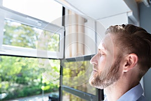 Man Breathing Fresh Air At Home