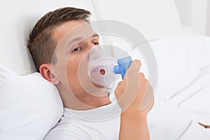Man Breathing Through Inhaler Mask