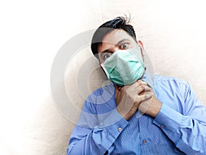 Man breathing problem pain in neck wear face mask open eye in pain hands on neck