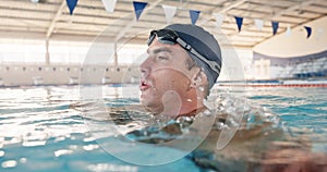 Man, breathing and tired from swimming in pool, exercise and fitness for sport. Male athlete, workout and recovery in