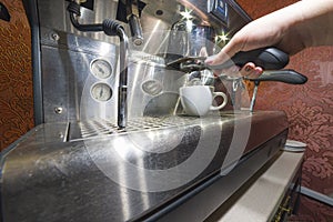 A man brews coffee at an automatic coffee machine