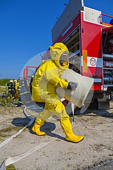 Man with briefcase in protective hazmat suit