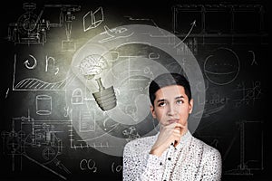 Man and bright bulb over icons background.