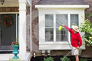 Man washing the bump-out or bay windows photo