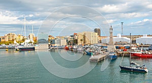 Man brings his sailboat dead slow into Port Vell Marina in Barcelona, Spain.