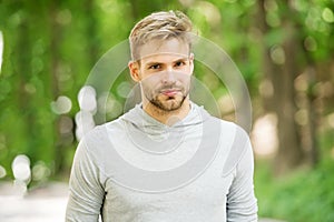 Man with bristle on calm face, nature background, defocused. Skin care concept. Man with beard or unshaven guy looks