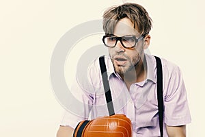 Man with bristle and dull face wears boxing gloves.