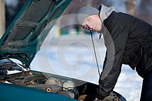 Man with broken car in winter