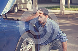 Man with broken down car flat tire