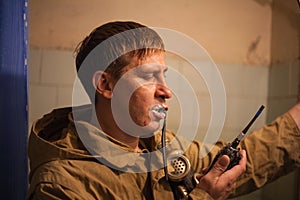 A man brushes his teeth during a chemical hazard