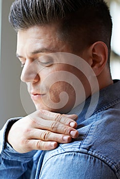 Man Brushing Dandruff From Shoulders