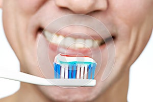 Man brushing teeth toothbrush with toothpaste