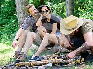 Man brutal bearded hipster prepares bonfire in forest. Ultimate guide to bonfires. How build bonfire outdoors. Camping