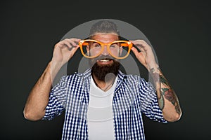 Man brutal bearded hipster wear funny eyeglasses accessory. Human strengths and virtues. Positive mood. Positive