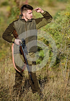 Man brutal unshaved gamekeeper nature background. Hunting permit. Bearded serious hunter spend leisure hunting. Hunter