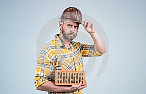 man build house. mature builder in shirt. unshaven man on construction site. handsome building worker in hard hat. labor