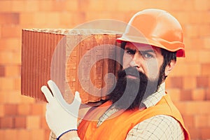 Man builder. Bricklayer, brickwork, building business. New apartments, new building. Bearded construction worker.