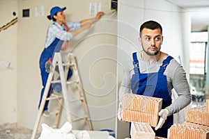 Man builder carrying bricks in construction site in apartment