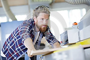 man builder with circular saw in workshop