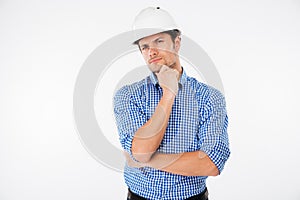 man builder in hard hat standng and thinking