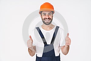 Man builder in helmet showing thumbs up gesture