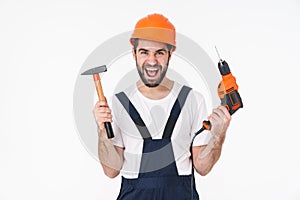 Man builder holding drill and hammer